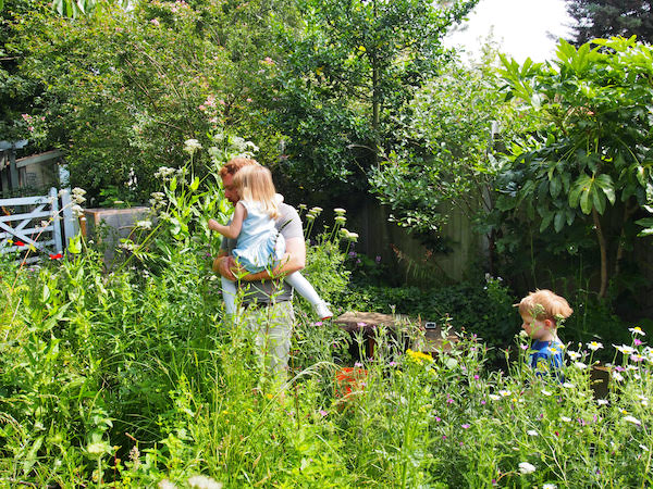 Joel with his kids in a garden